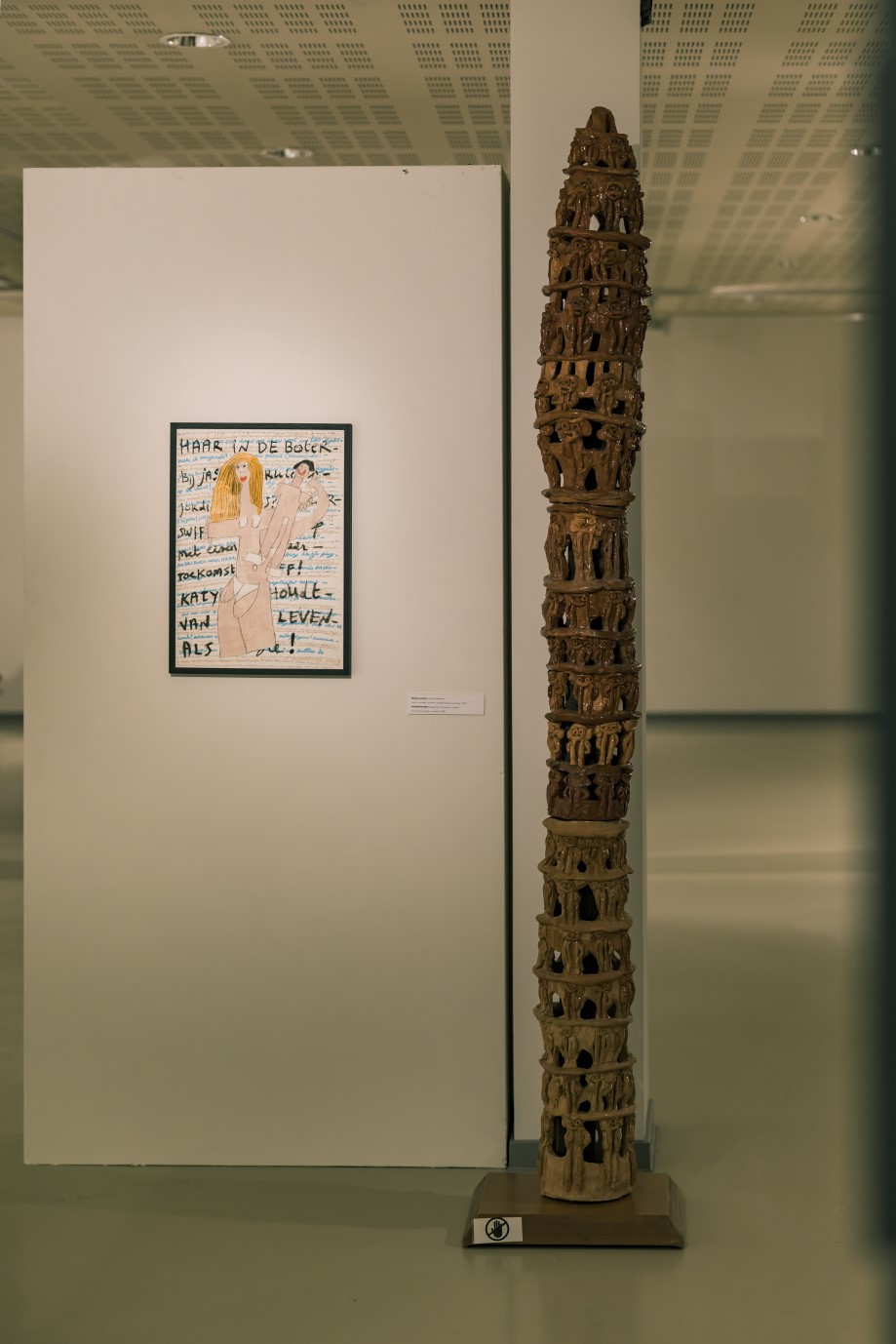 Tekening 'Haar in de boter' naast een hoge keramische sculptuur